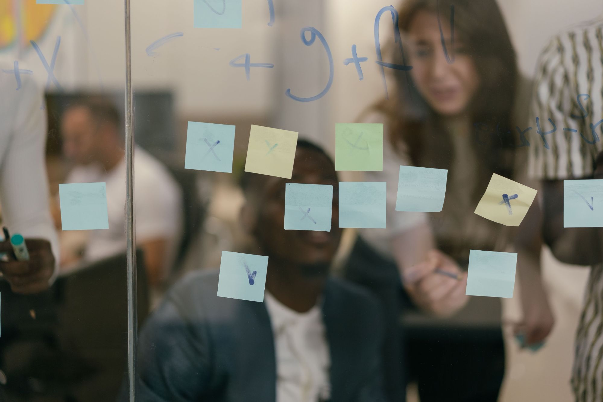 A team working together behind a glass wall